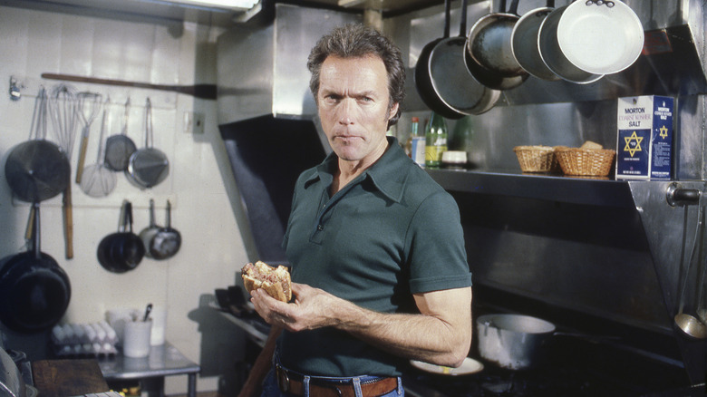 A younger Clint Eastwood eating a Dirty Harry burger in his restaurant