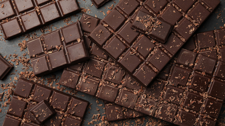 Bars of dark chocolate stacked on a black table