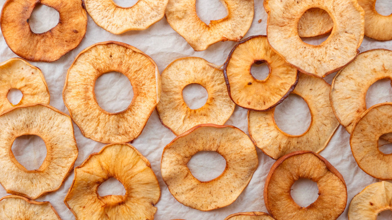 Dried apple rings on parchment paper