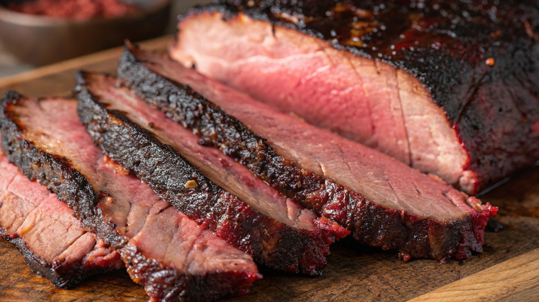 Smoked brisket sliced on cutting board