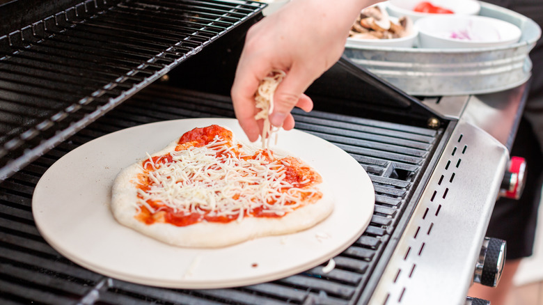 Pizza being prepared on a grill