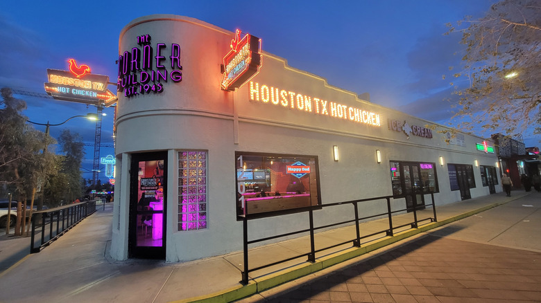 Streetside photo of a Houston TX Hot Chicken restaurant with neon signage