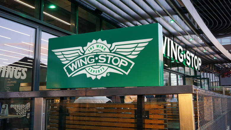 Closeup of Wingstop signage in the restaurant's outdoor seating area