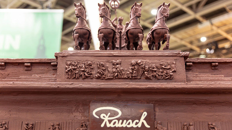 Chocolate sculpture of horses with the Rausch logo