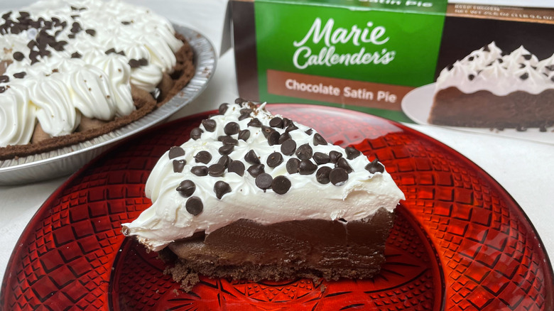 A slice of Marie Callender's Chocolate Satin Pie on a red glass plate