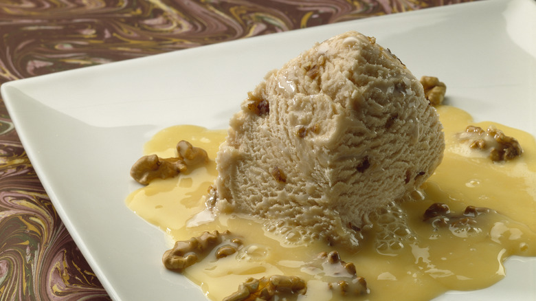 A plate of walnut ice cream with a sweet sauce