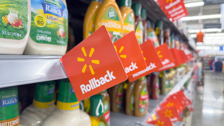 Salad dressing displayed on shelves inside Walmart with rollback signs