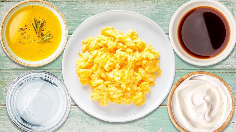 Scrambled eggs with bowls of liquid