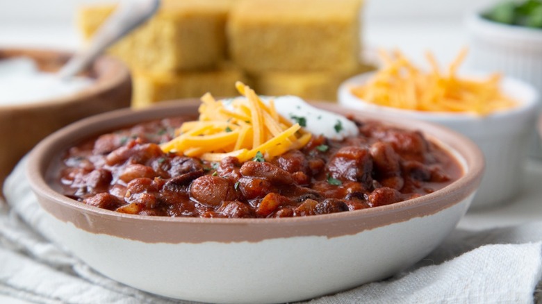 Up-close photo of a bowl of 3-bean chili topped with shredded cheese