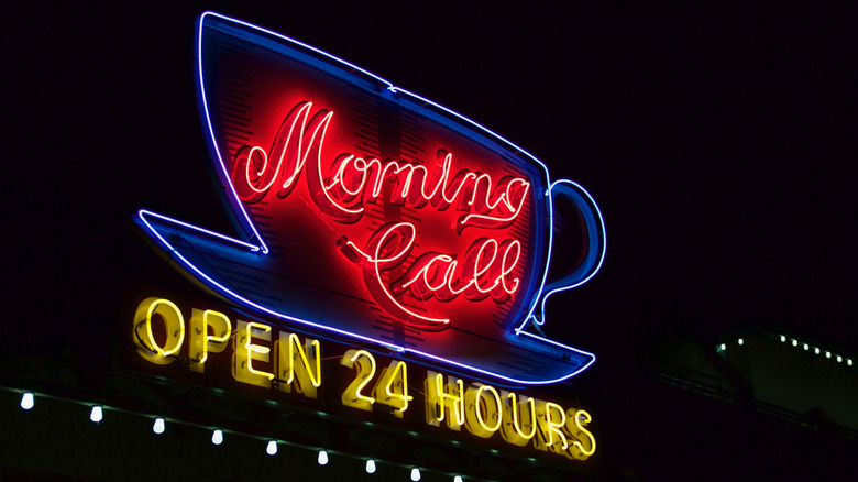 neon sign saying "open 24 hours" against a dark night sky