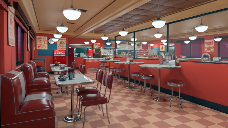 interior of a retro diner with red walls and upholstery, and chrome furniture