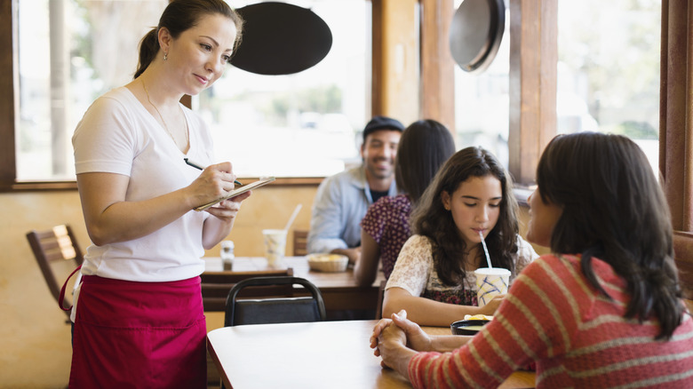 diner talking to server at restaurant