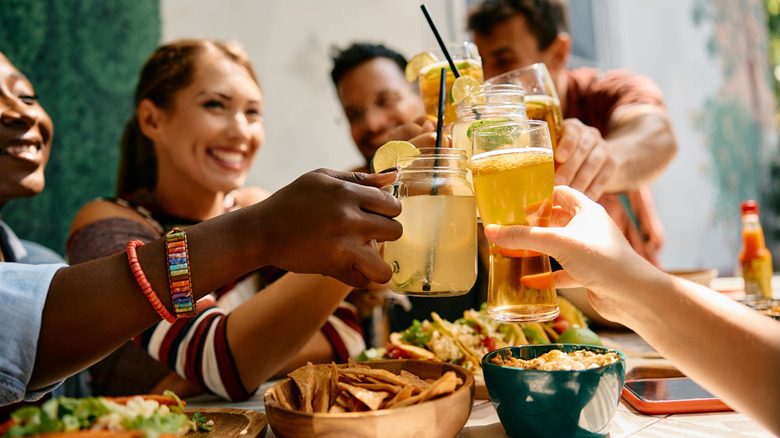group of friends toasting at Mexican restaurant