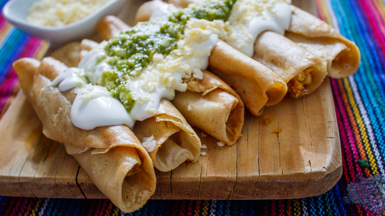 fried tacos covered in sour cream