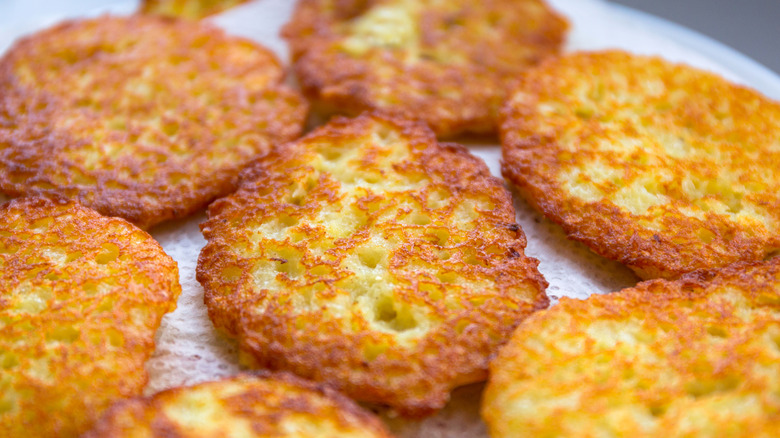 Freshly fried hard browns on a paper towel
