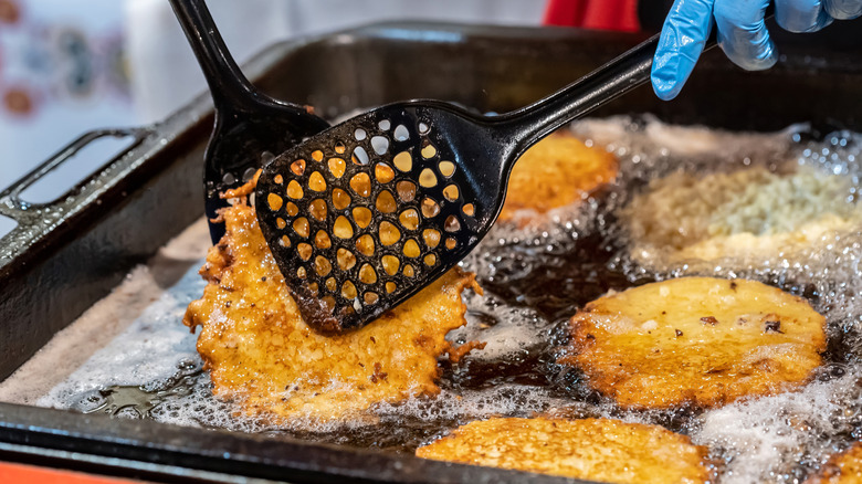 Hash browns being flipped with a spatula