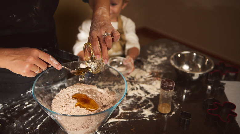 Spooning honey into recipe