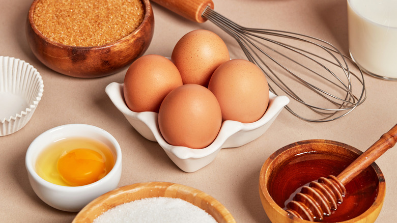 Baking ingredients on counter, including bowl of honey