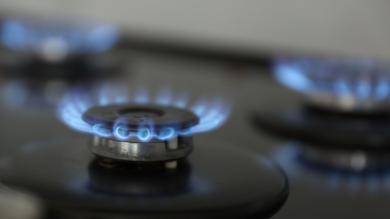 Lit gas burner on stove