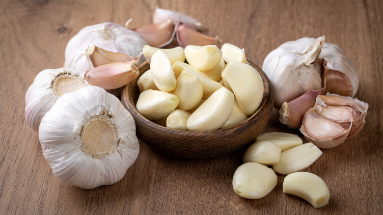 Bulbs and cloves of garlic on a wooden surface