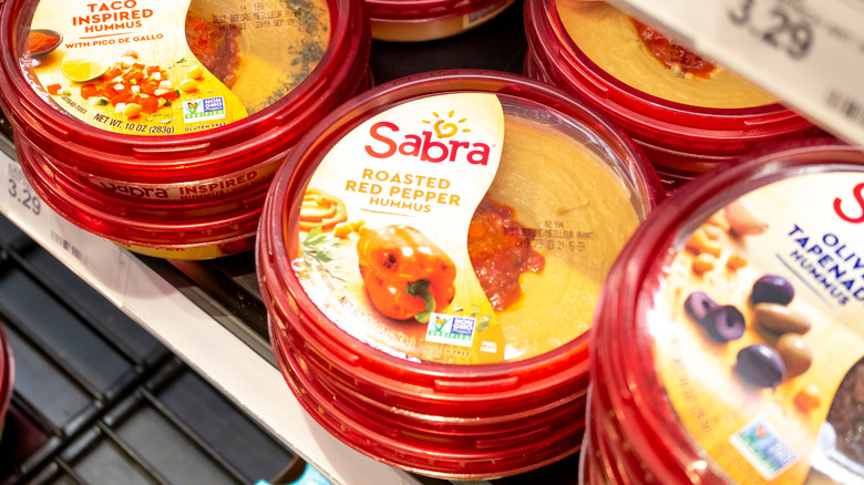Sabra hummus containers on shelves at grocery store