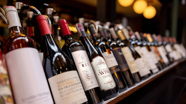 Bottles of wine displayed on the rack at a winery