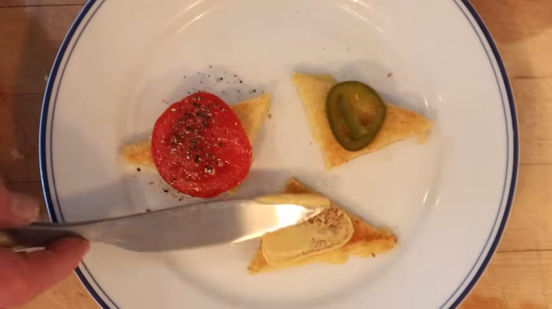 Open-faced mini cheese dream sandwiches being seasoned with various toppings