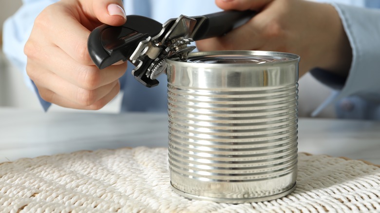 Person using can opener