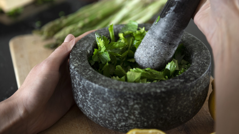 Shot of person's hands using mortar and pestle