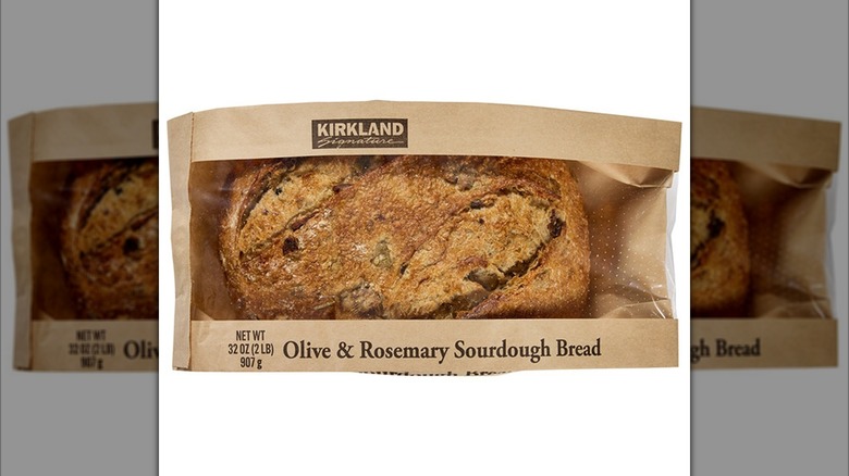 Close-up of Kirkland Signature Olive & Rosemary Sourdough Bread in brown paper sleeve