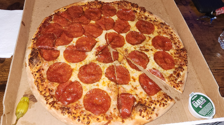 A pepperoni Papa Johns pizza with pepperoncini and Special Garlic Sauce