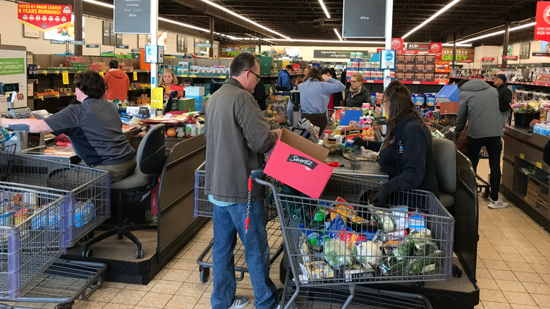 Aldi employees ringing up groceries at register