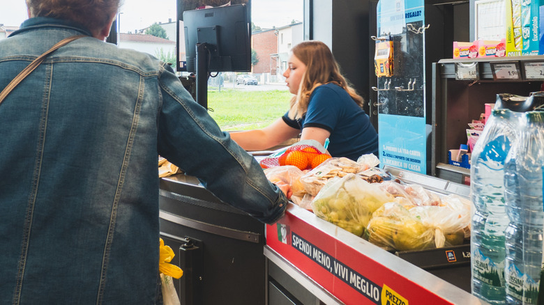 Woman scanning groceries at Aldi checkout