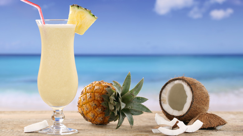 Pineapple, coconut, and cocktail  by the ocean. 