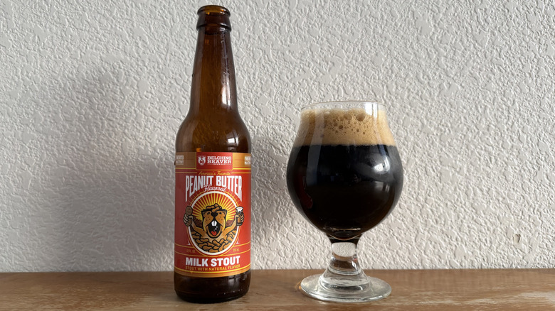 Belching Beaver Peanut Butter Milk Stout bottle beside a full glass