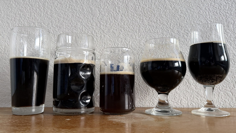 Five beer glasses, all about three-quarters full
