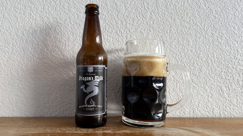New Holland Dragon's Milk bottle beside a mostly full glass