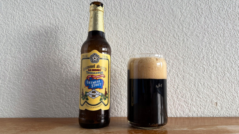 Samuel Smith Oatmeal Stout bottle beside a full glass