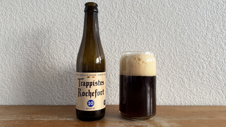 Trappistes Rochefort 10 bottle beside a full glass