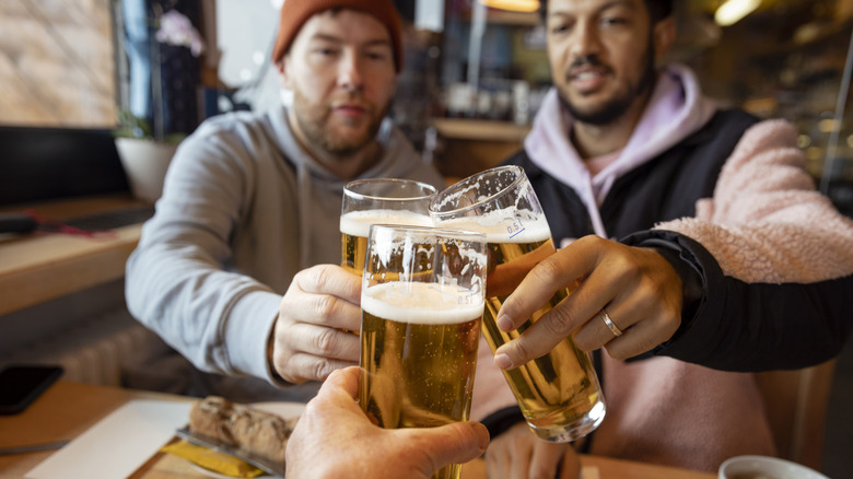 Group of friends toasting with beer