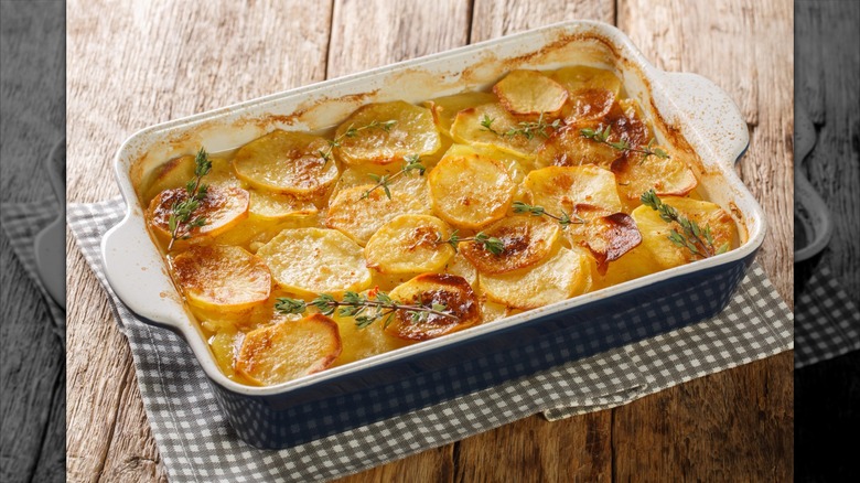 Scalloped potatoes served in a rectangular casserole dish on a table