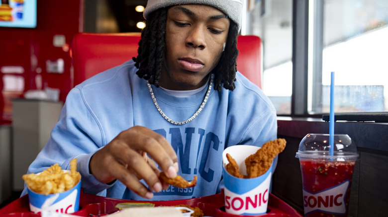Jahmyr Gibbs eating tray of food at Sonic