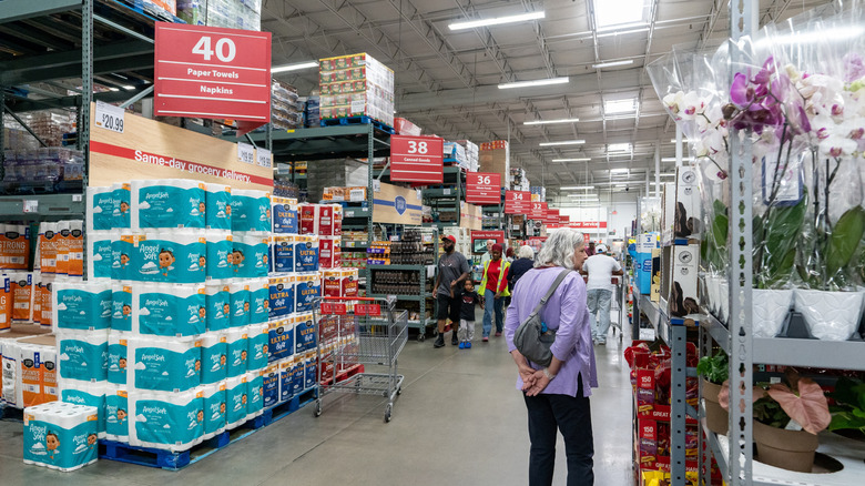 Shoppers in wide warehouse aisles at BJ's Wholesale Club