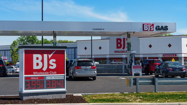 Cars go through a BJ's Wholesale Club gas station during the day