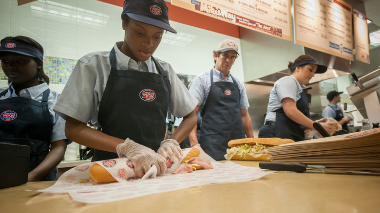 Jersey Mike's employees making sandwiches.