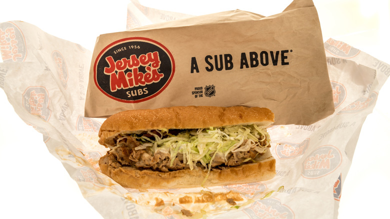 A Jersey Mike's sub next to the bag it came in.