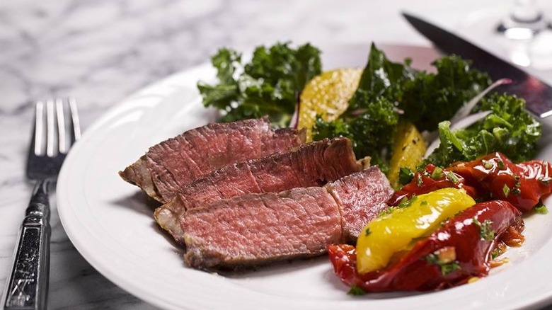 A close up of a lunch plate with a sliced meat and food from Market Table