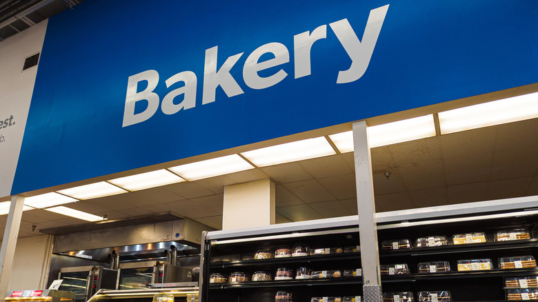 Sam's Club bakery sign with cakes in fridge below
