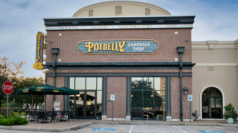 Exterior of Potbelly Sandwich shop with brick facade and empty parking lot spots