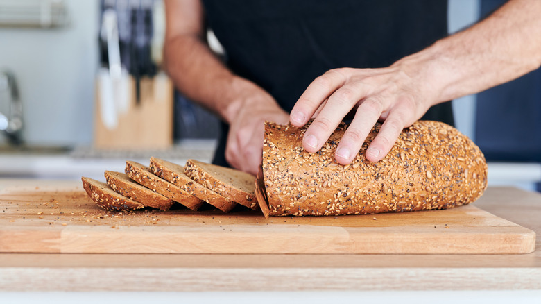 Hands cutting slices of bread